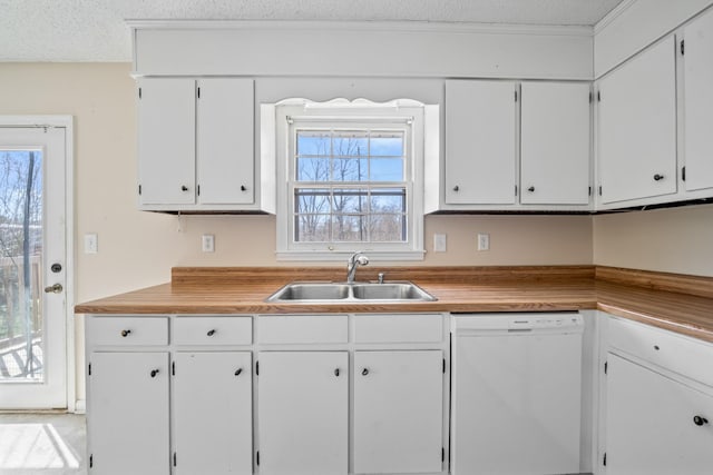 kitchen featuring dishwasher, light countertops, a textured ceiling, white cabinetry, and a sink