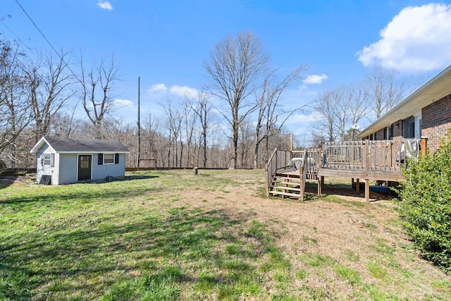 view of yard featuring an outbuilding and a wooden deck