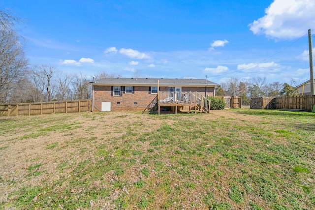 back of property with a fenced backyard, brick siding, stairs, crawl space, and a wooden deck