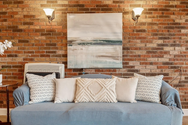 interior space featuring brick wall and heating unit