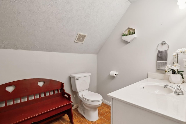 bathroom with visible vents, toilet, vaulted ceiling, a textured ceiling, and tile patterned flooring