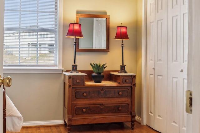 bedroom featuring a closet, baseboards, and wood finished floors