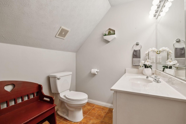 bathroom featuring a textured ceiling, lofted ceiling, toilet, vanity, and visible vents