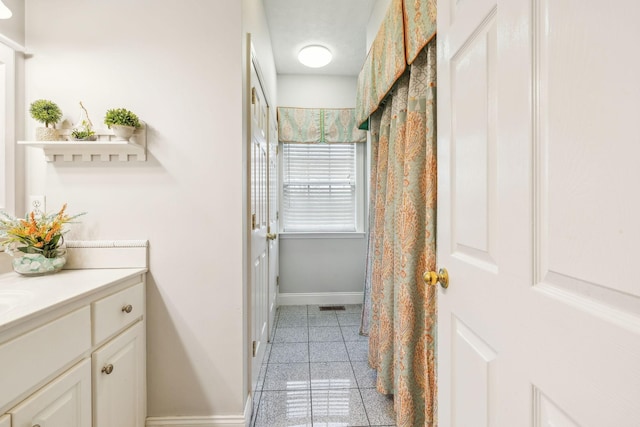 bathroom with granite finish floor, visible vents, baseboards, and vanity