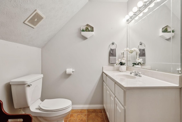 bathroom with visible vents, toilet, vaulted ceiling, a textured ceiling, and baseboards