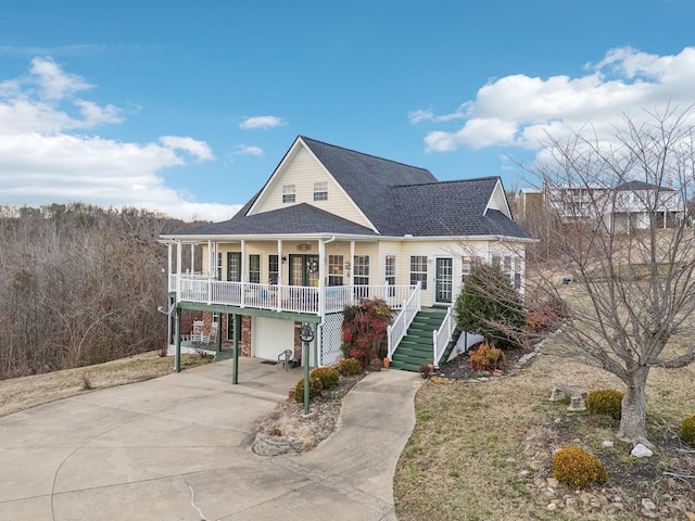 view of front of home featuring a porch, stairway, an attached garage, a carport, and driveway