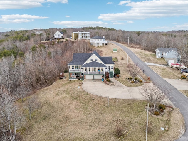 drone / aerial view featuring a forest view