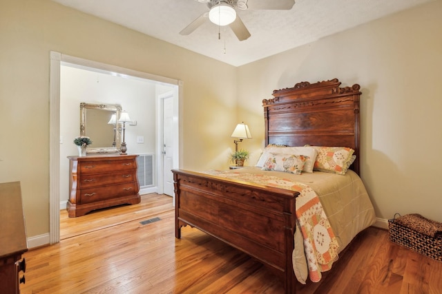 bedroom featuring visible vents, ceiling fan, and light wood-style flooring