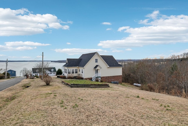 view of side of home with a lawn and brick siding