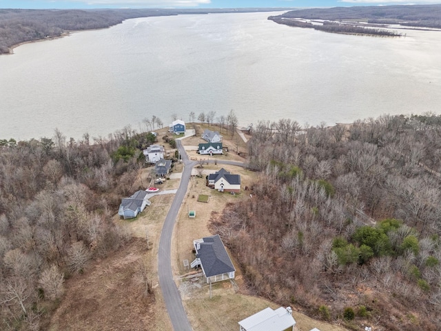 aerial view with a water view and a wooded view