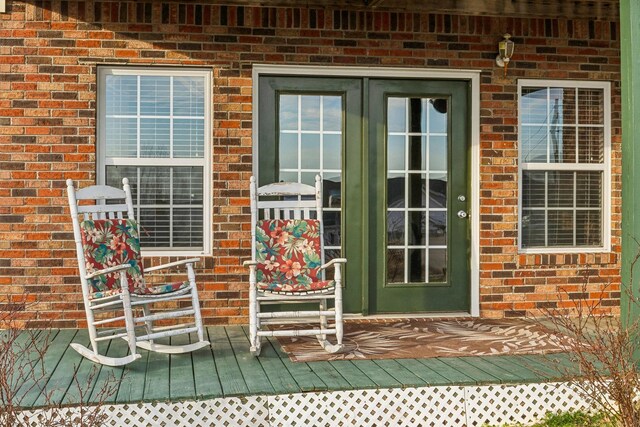 view of exterior entry with brick siding