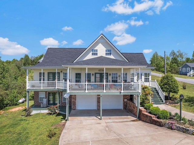 view of front of home featuring a garage, driveway, a porch, and a front lawn