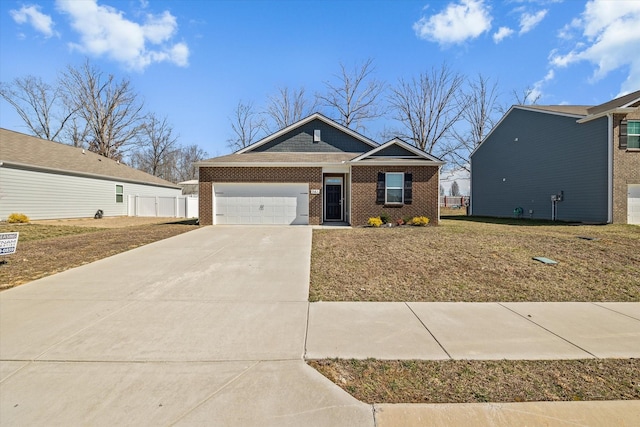 view of front of property with a garage, brick siding, fence, concrete driveway, and a front yard