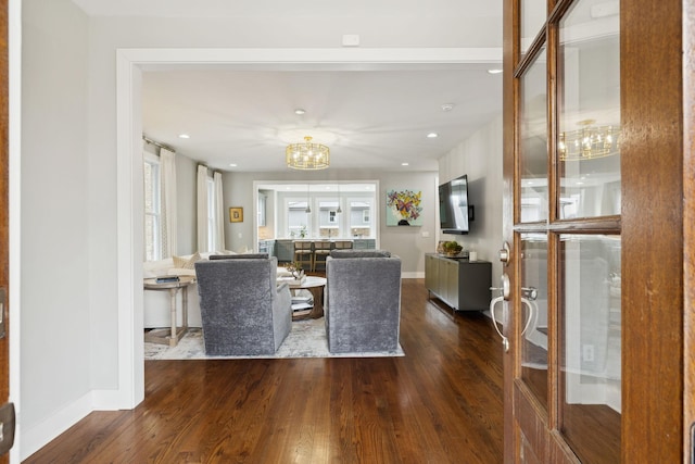 living room featuring baseboards, dark wood finished floors, a notable chandelier, and recessed lighting