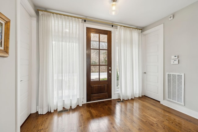 entryway with wood finished floors and visible vents