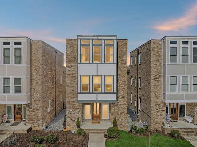 view of front facade featuring a patio area and brick siding