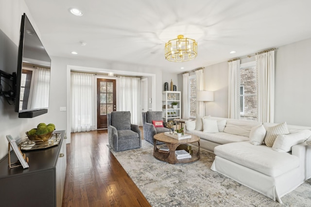 living room with a notable chandelier, wood finished floors, and recessed lighting