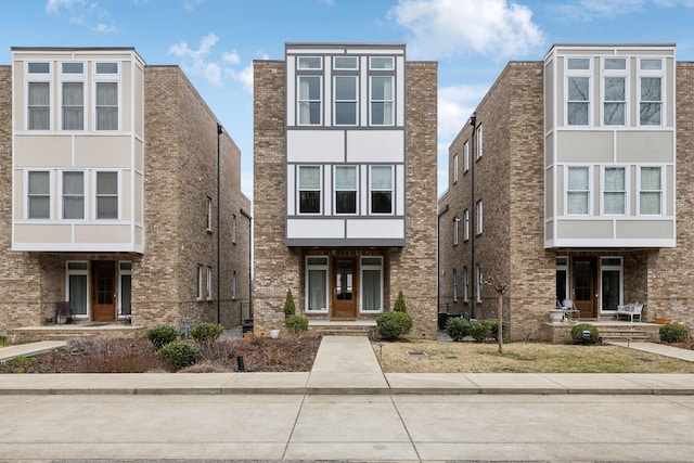 view of front of house featuring brick siding and stucco siding