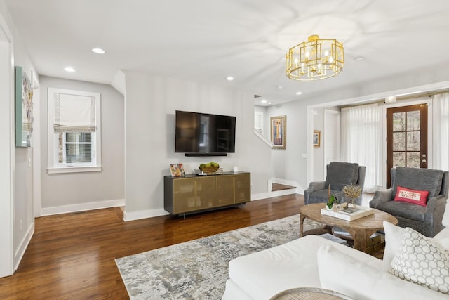 living area featuring baseboards, an inviting chandelier, wood finished floors, and recessed lighting