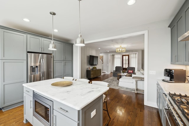 kitchen featuring stainless steel appliances, dark wood-style flooring, recessed lighting, and gray cabinetry