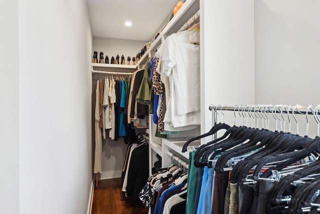 walk in closet with wood finished floors