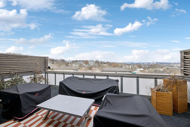 wooden deck with a city view and area for grilling