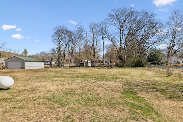 view of yard featuring fence and an outdoor structure