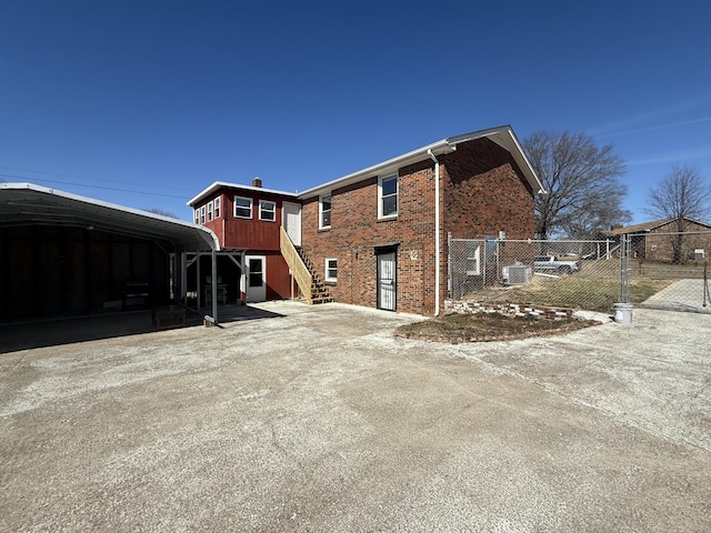 back of property with brick siding and fence