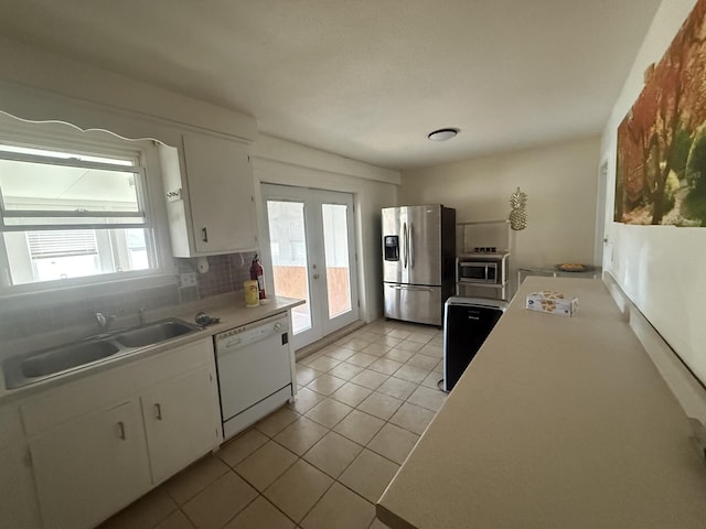 kitchen featuring a wealth of natural light, appliances with stainless steel finishes, a sink, and french doors