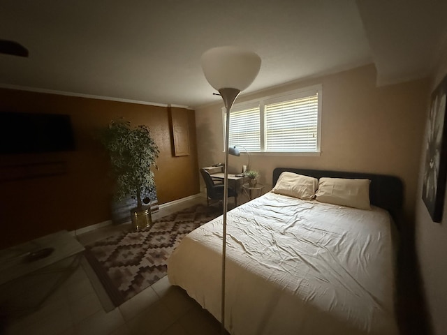 bedroom featuring baseboards and tile patterned floors