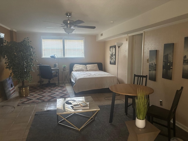 bedroom with tile patterned flooring, visible vents, and ceiling fan