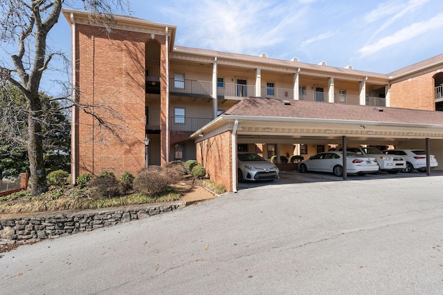 view of building exterior featuring covered parking