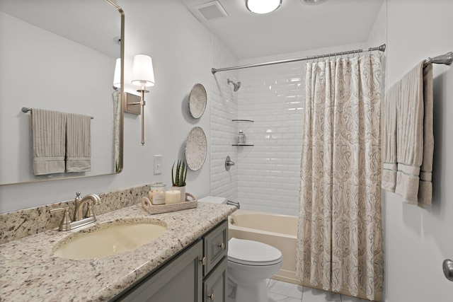 bathroom with toilet, shower / tub combo, visible vents, and vanity