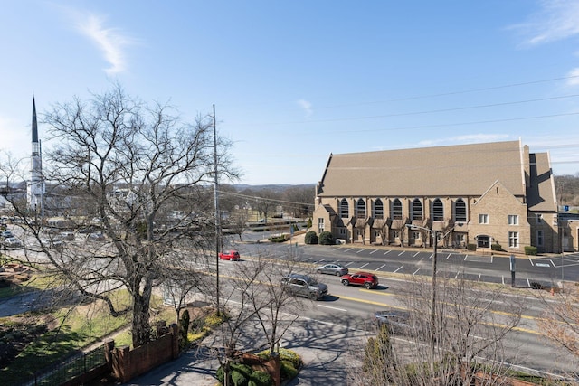 view of property featuring uncovered parking and fence