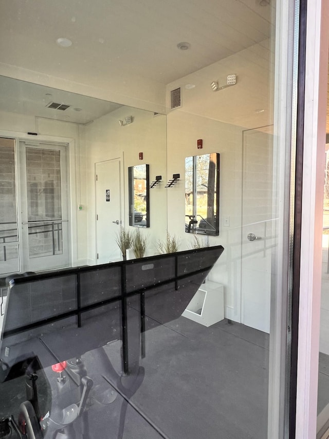 bathroom featuring concrete flooring and visible vents