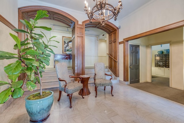 sitting room featuring ornamental molding, arched walkways, and a chandelier