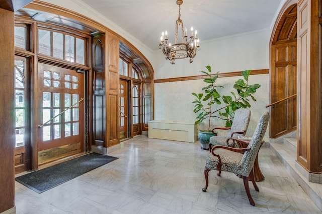 foyer entrance with an inviting chandelier, arched walkways, and ornamental molding