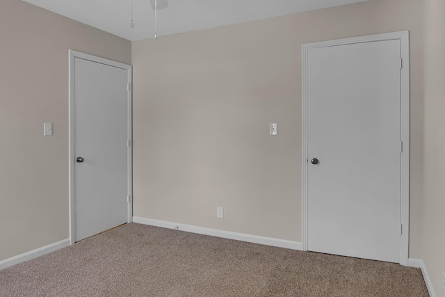 carpeted spare room with baseboards