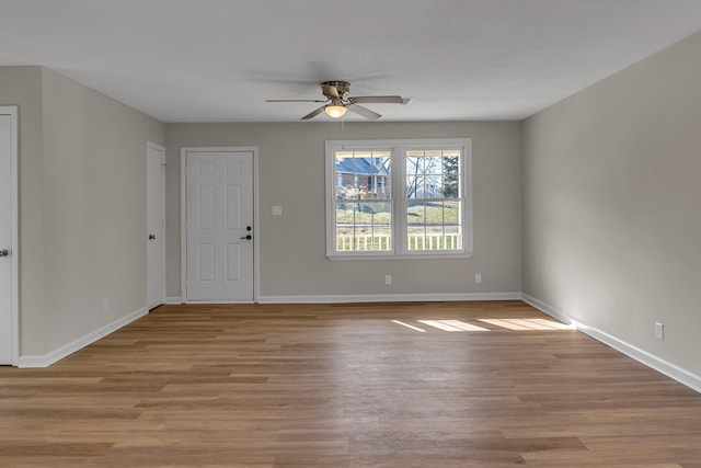 interior space with baseboards and wood finished floors