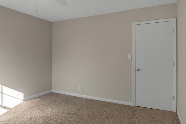 unfurnished room featuring ceiling fan, carpet flooring, and baseboards