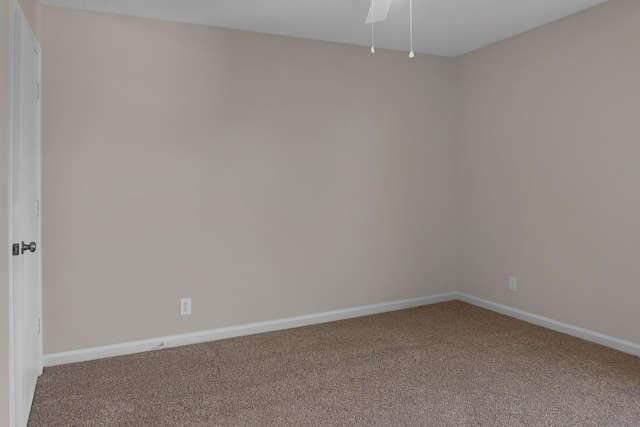 carpeted spare room with baseboards