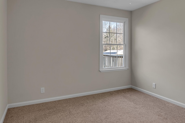 unfurnished room with carpet floors and baseboards