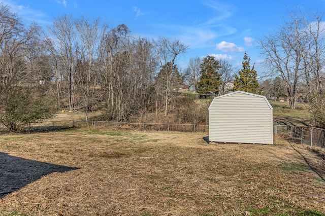 view of yard with an outbuilding, fence, and a storage shed