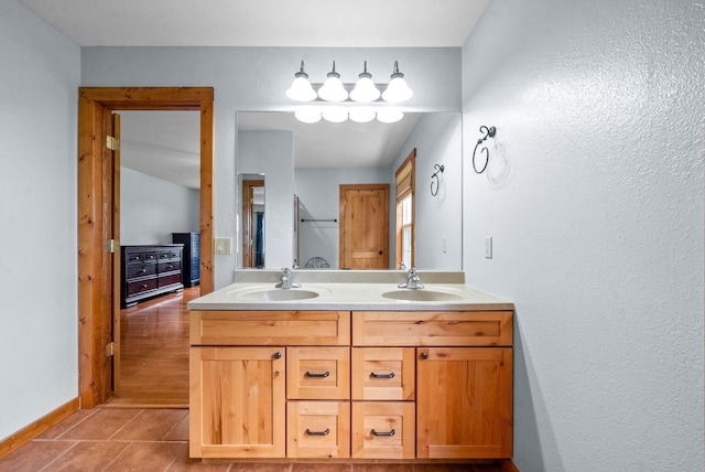 765 Heron Rd, Murray, KY 42071 - bathroom with baseboards, double vanity, a sink, and tile patterned floors