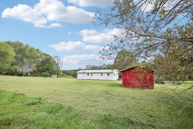 view of yard featuring an outbuilding and a storage shed