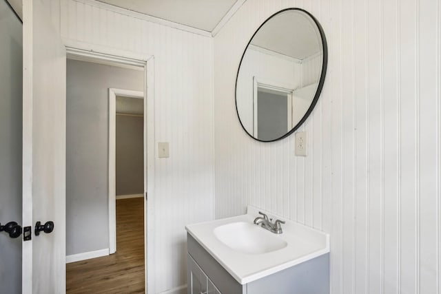 bathroom featuring vanity, baseboards, and wood finished floors