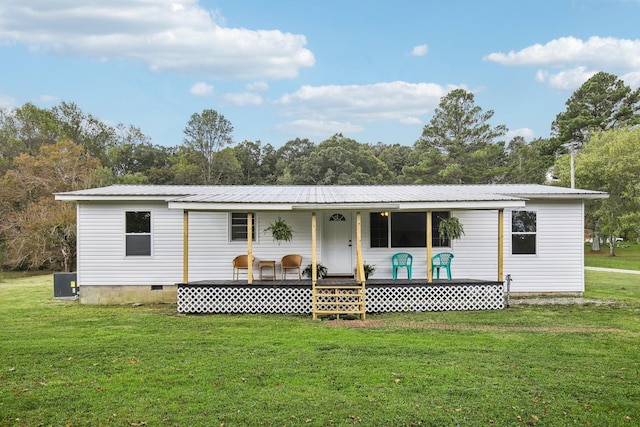 rear view of house with crawl space, metal roof, a porch, and a yard