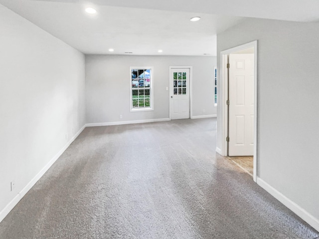 spare room featuring recessed lighting, carpet flooring, and baseboards