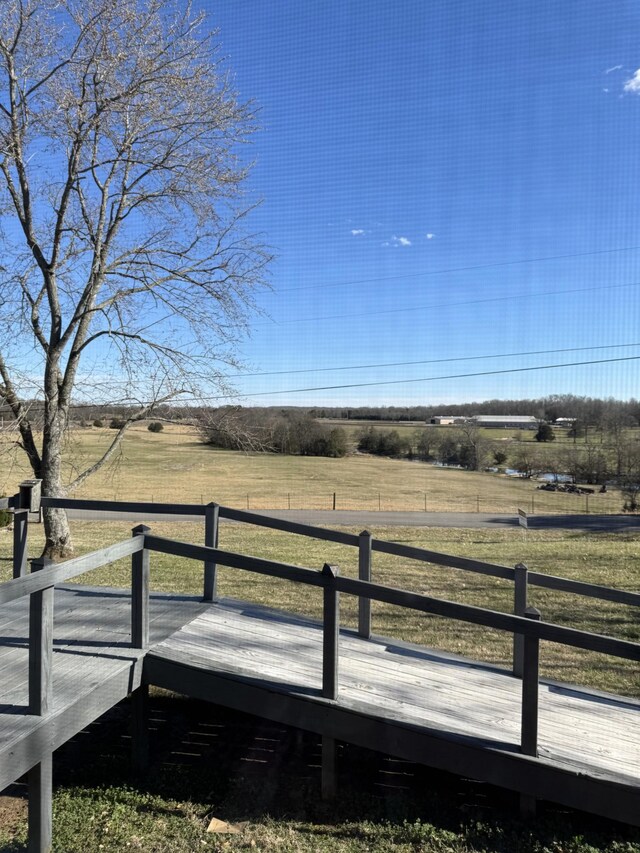 view of yard featuring a rural view and a deck