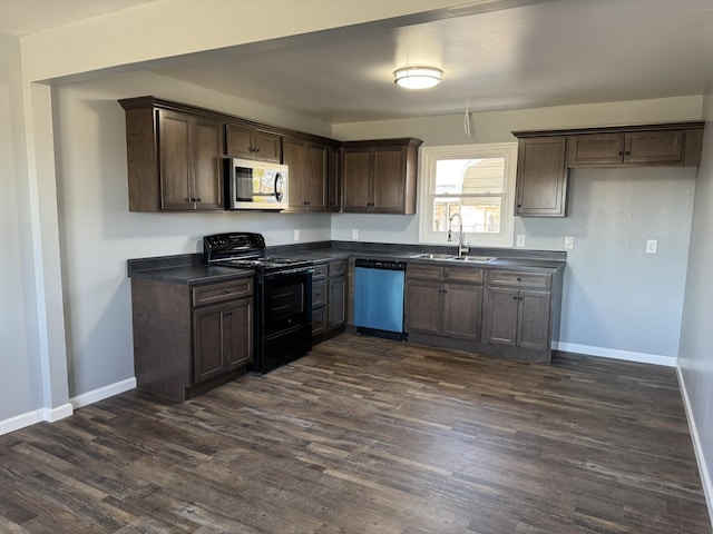 kitchen featuring dishwashing machine, a sink, black electric range, stainless steel microwave, and dark countertops